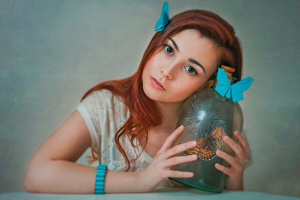 Portrait of a red-haired girl with butterflies