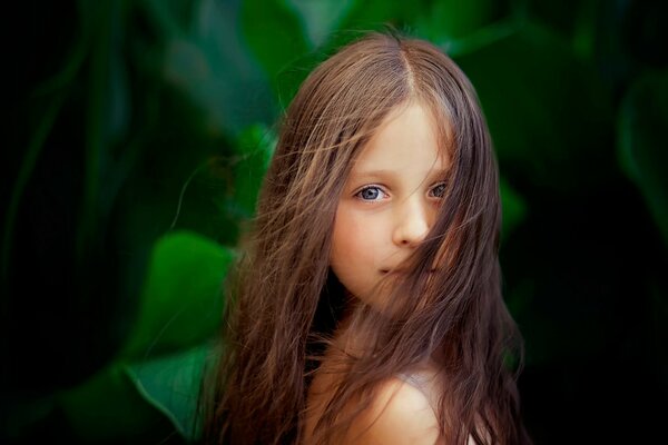 A girl with long hair on a green background