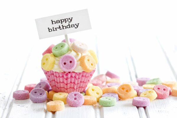 A bright cake decorated with colorful edible buttons