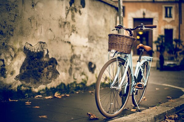 Bike on the street at the wall of the house