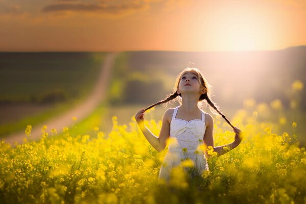 Girl with pigtails on the background of the sun and the road wallpaper