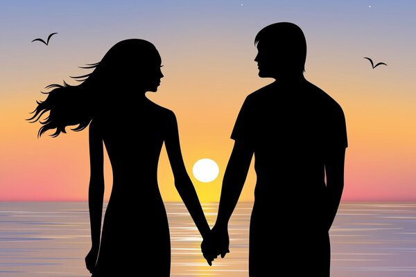 Girl and guy holding hands at sunset