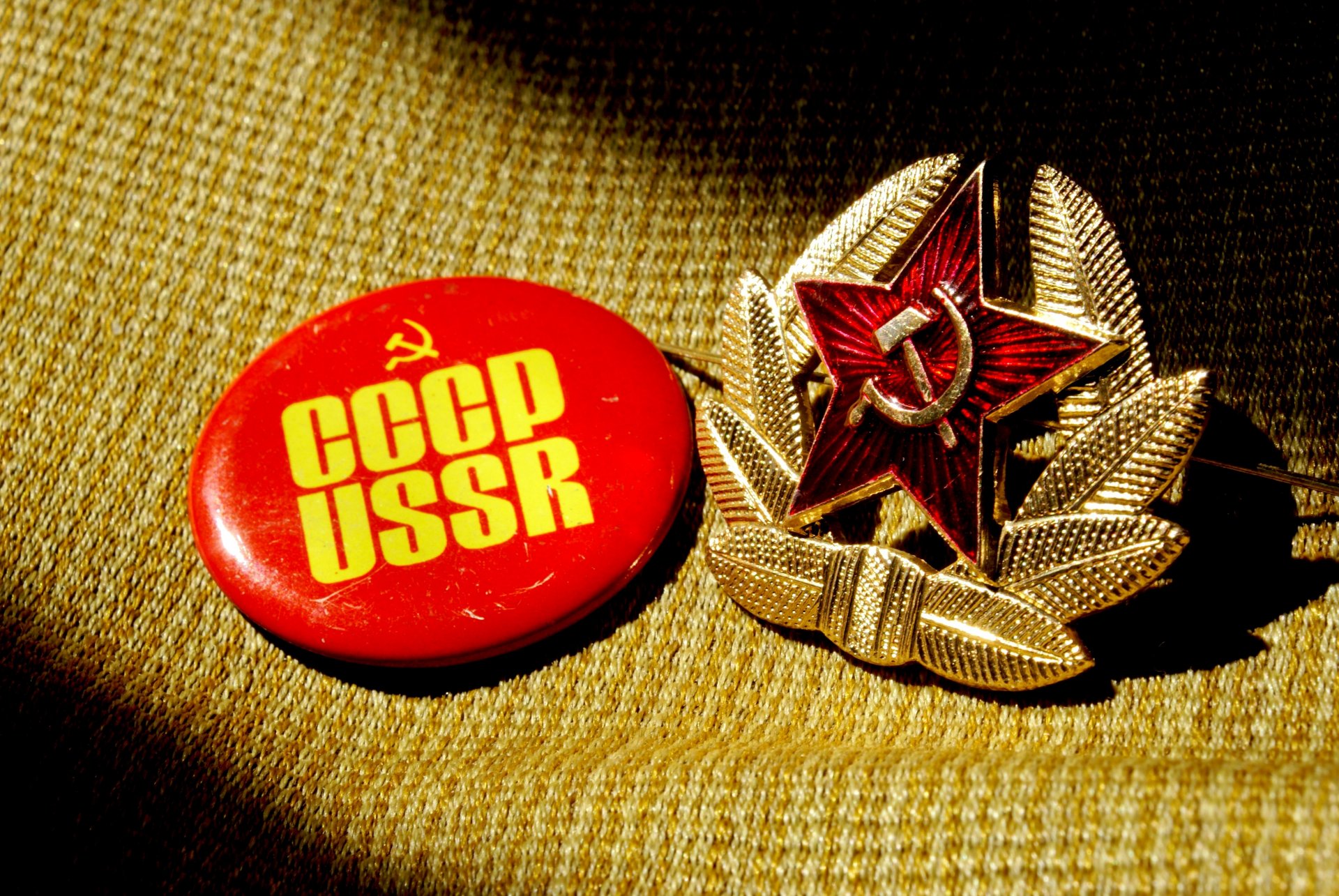 badge ussr cockade star sickle hammer fabric background shadow