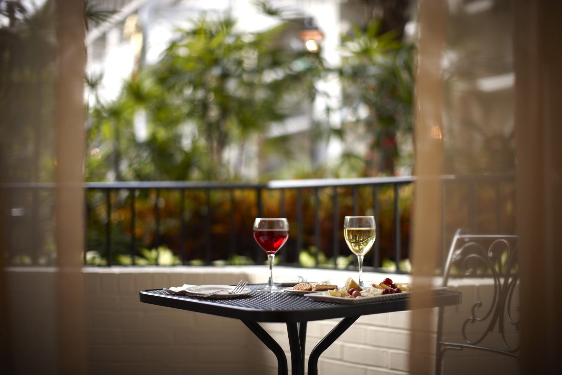 balcony table food glasses wine