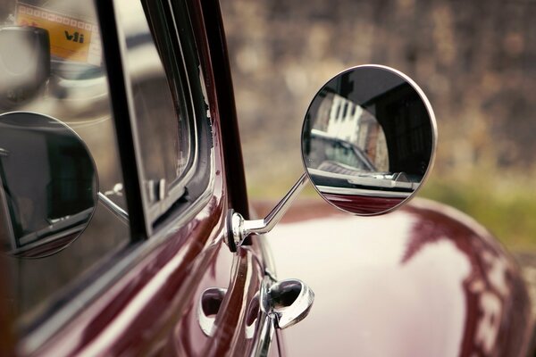 Side mirror of a red car