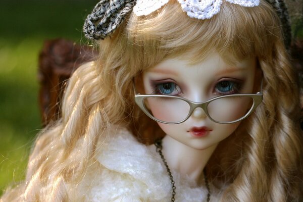 Doll with white hair , glasses on the doll