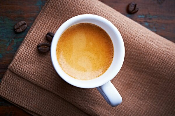 A mug of fragrant espresso with milk foam on top