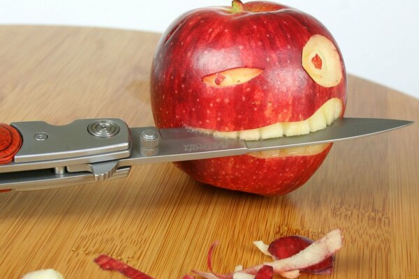 An apple eats a knife on the table