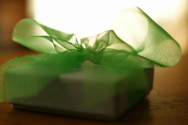 White gift box with green bow