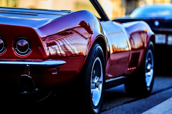 Red Chevrolet Cabriolet Driveway Lavender bushes Black fence in traffic