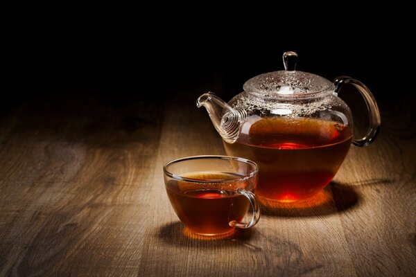 Glass and teapot on a wooden table