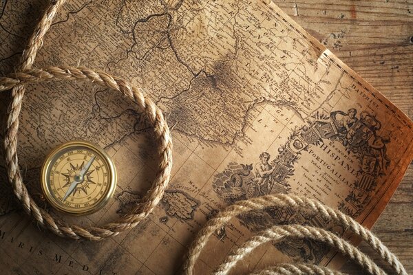 The treasure map and compass are on the table