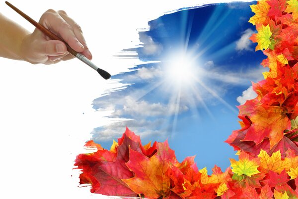 A hand with a brush risks red maple leaves and the sky