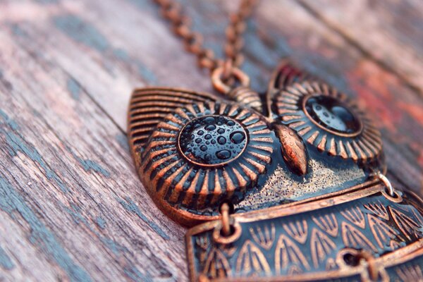 Owl pendant on a wooden table