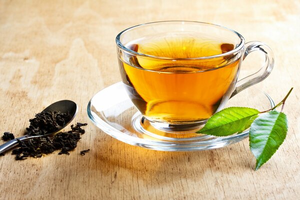 Tea in a transparent cup with a leaf