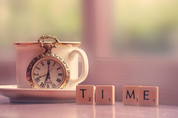 The picture on the table is a cup with a saucer and cubes