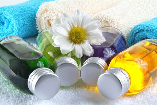 Bottles of multicolored liquid lying on a towel