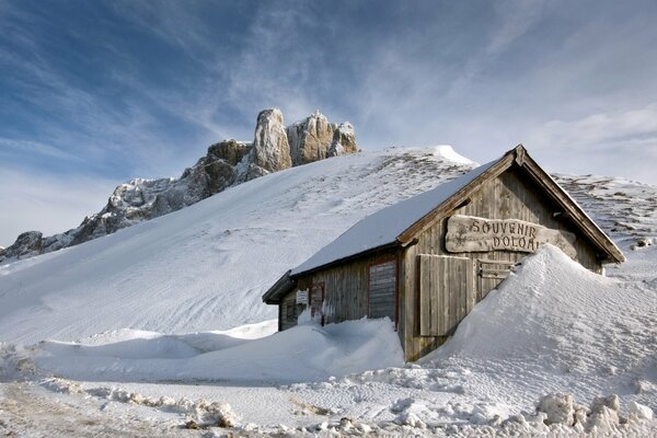 A snow-covered house in the mountains