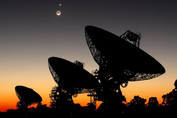 The parabolic antenna of the radio telescope in search of the Moon and Venus