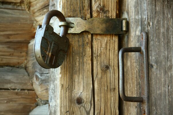 Old padlock on a wooden door