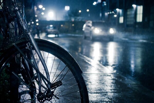 Bike on the night street in rainy weather