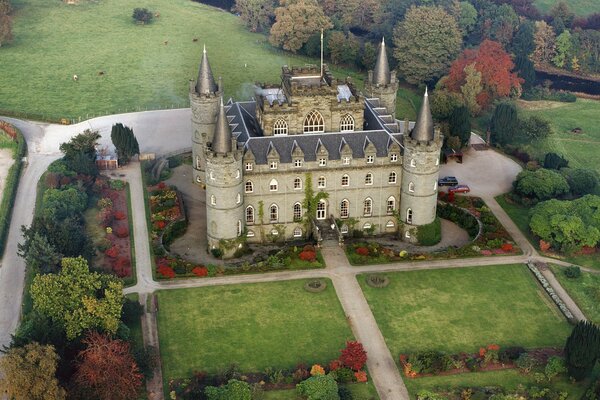 A beautiful castle with a meadow by the river