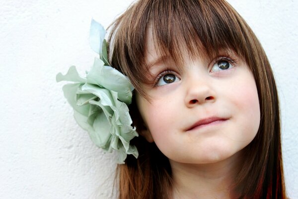 A beautiful child with a flower in her hair