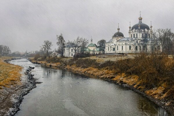 Temple on the river bank in the rain