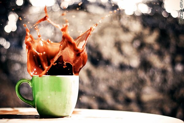 Splashes of coffee from a green cup