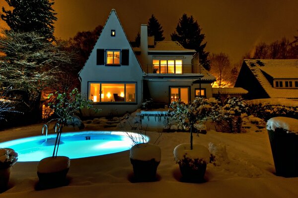 The light in the windows illuminates the pool