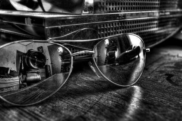 Reflection of the camera lens in glasses