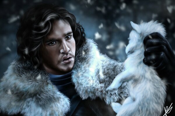 Game of thrones. Jon Snow with a wolf cub in his hands