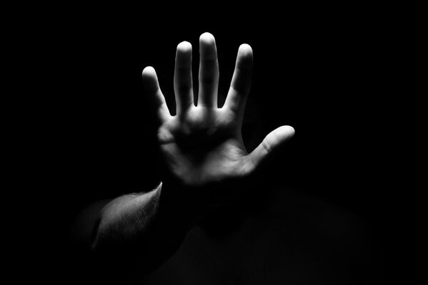 Black and white photo of a hand palm forward