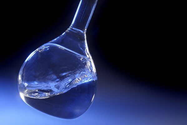 Water in a flask on a blue background