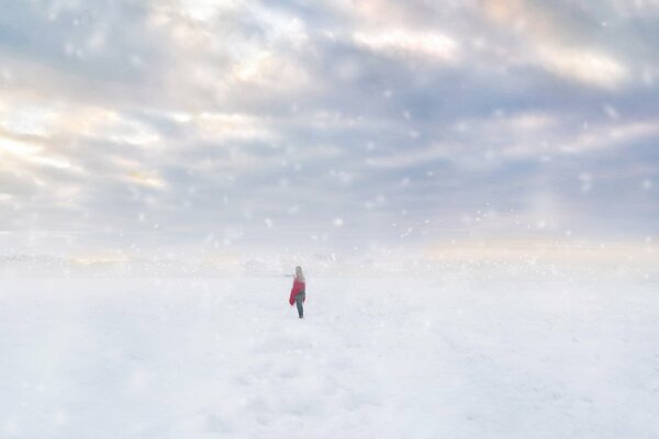 A lonely girl on a snowy field