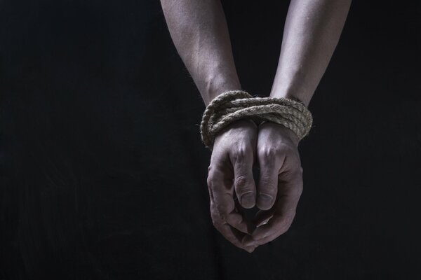 Human hands tied with a rope