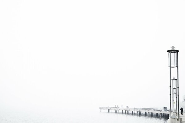 A man walking along the pier