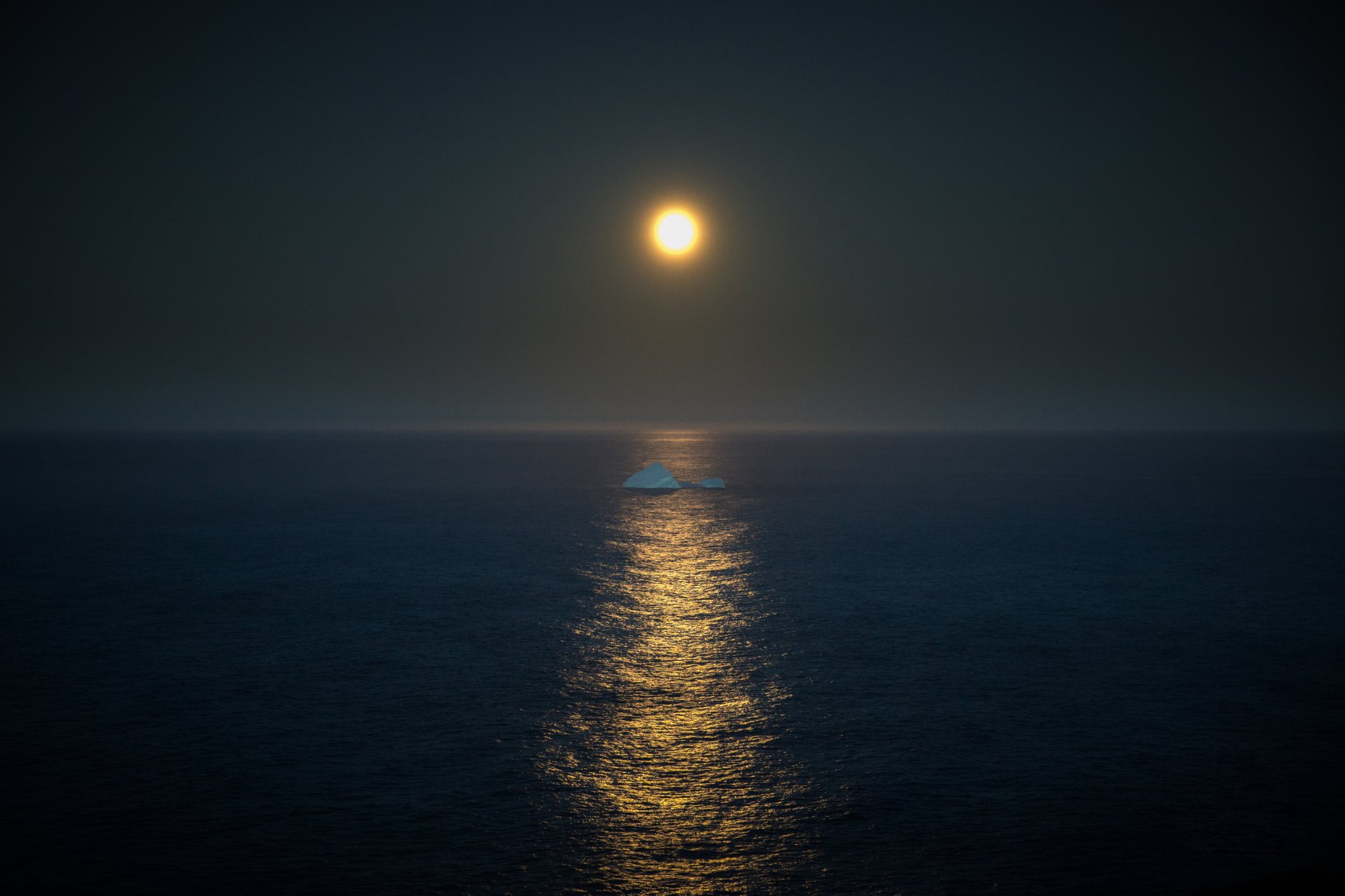 iceberg full moon mirror reflection light horizon sea gray sky