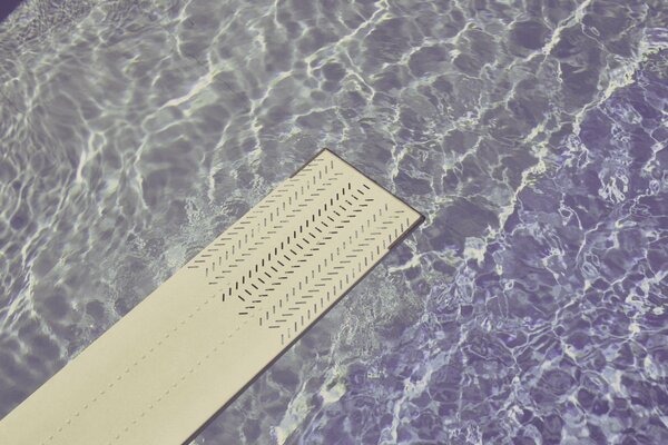 Springboard over the rippling water in the pool