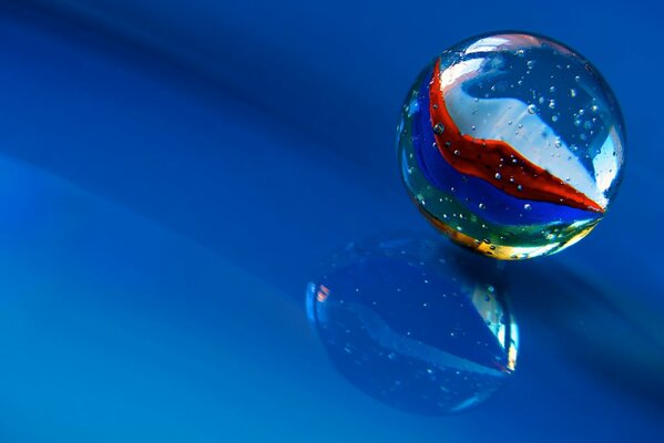 Macro shooting of a multicolored ball on a blue background