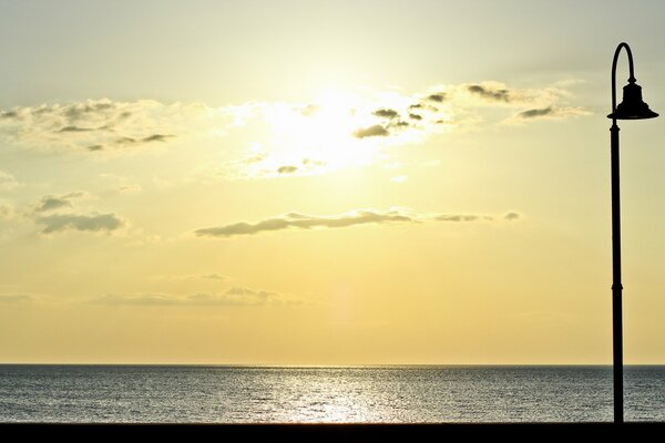 Sea sunset and street lamp