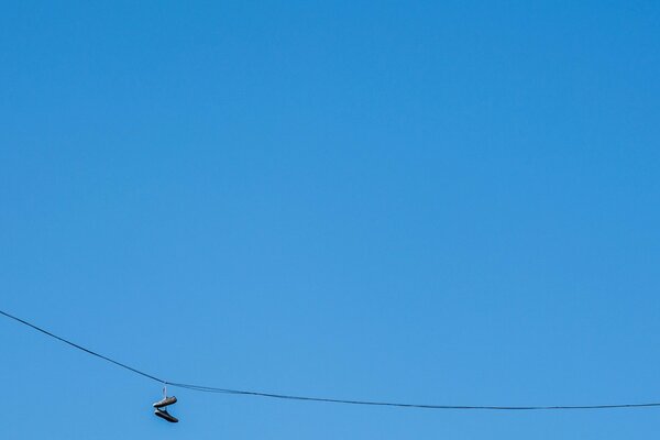 Sneakers in a minimalist style on a blue sky