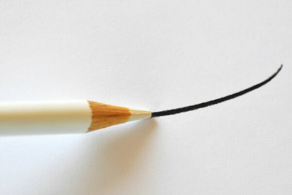 A white pencil draws a black line