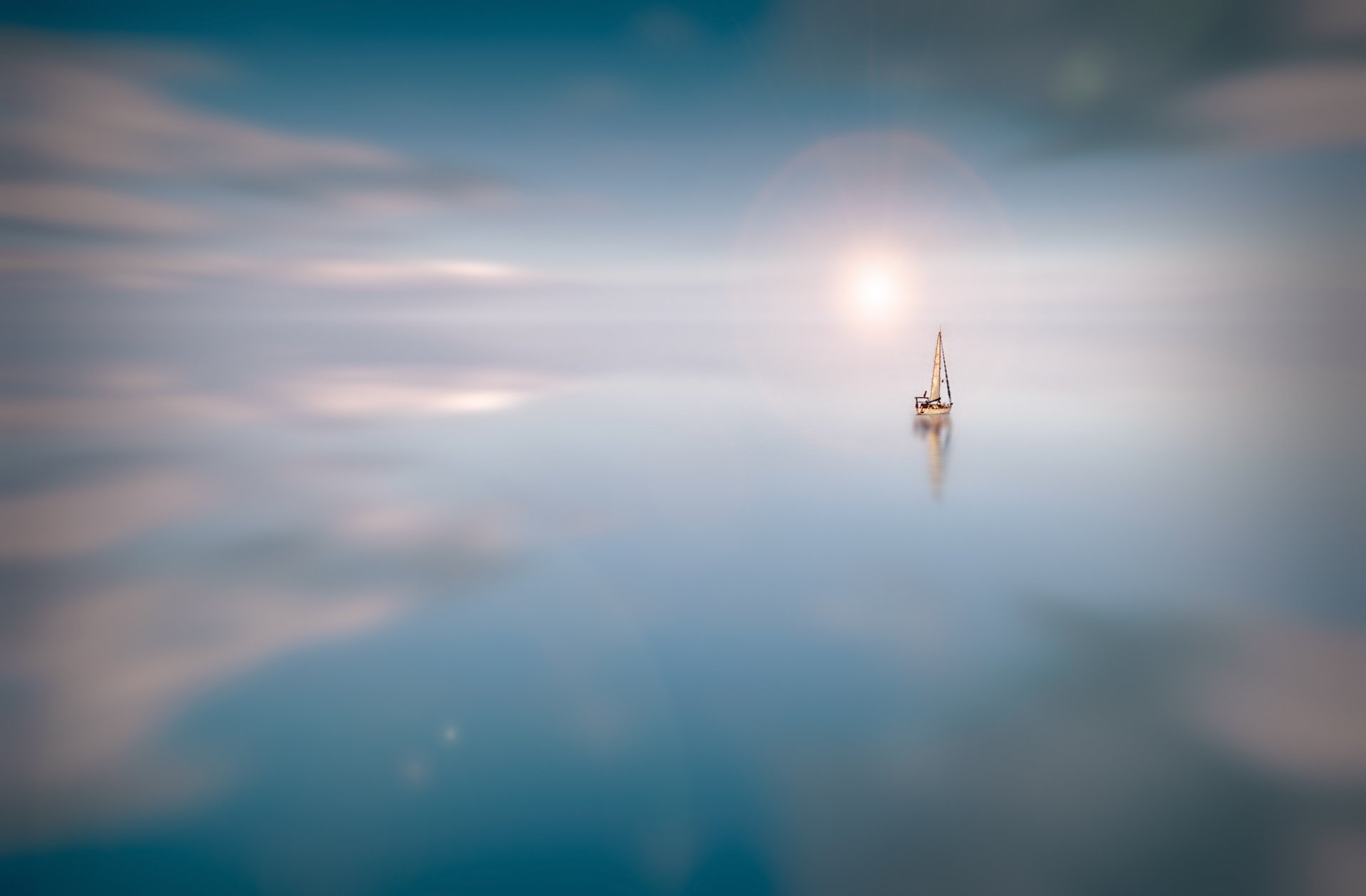 water surface of sailboats sun clouds reflection