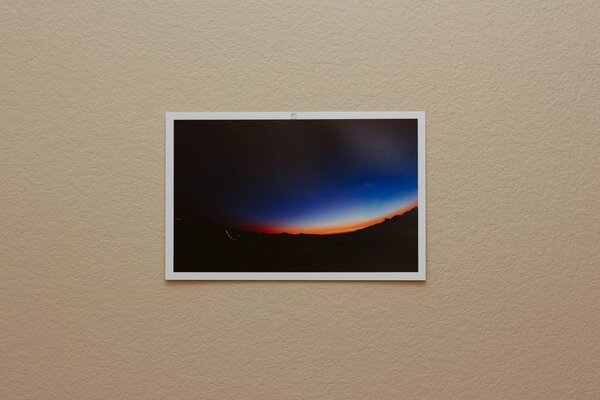 A photo of the dawn is hanging on the wall