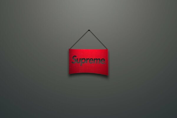 Das Supreme-Logo. auf dem roten Schild. Grauer Hintergrund