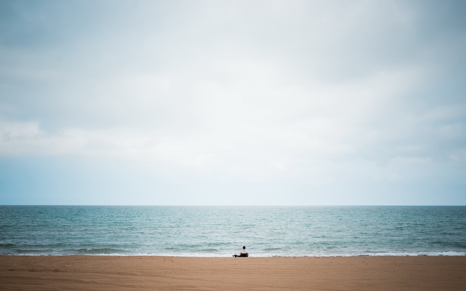 alone solitude man big lake beach sky blue