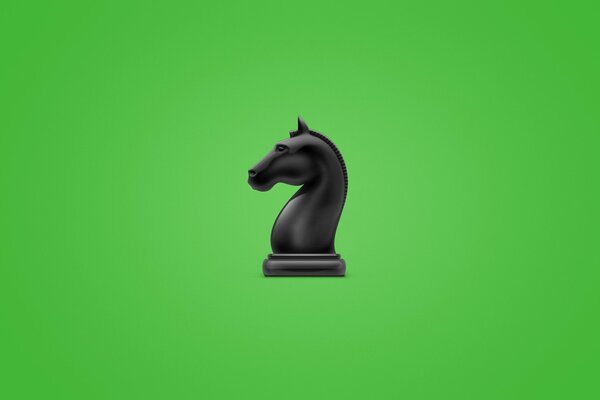 Figura di scacchi, cavallo nero. Raffigurato su sfondo verde