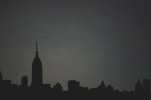 Outlines of a city with skyscrapers on a gray background