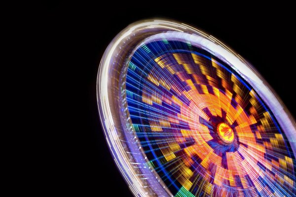 Multicolored Ferris wheel on a black background